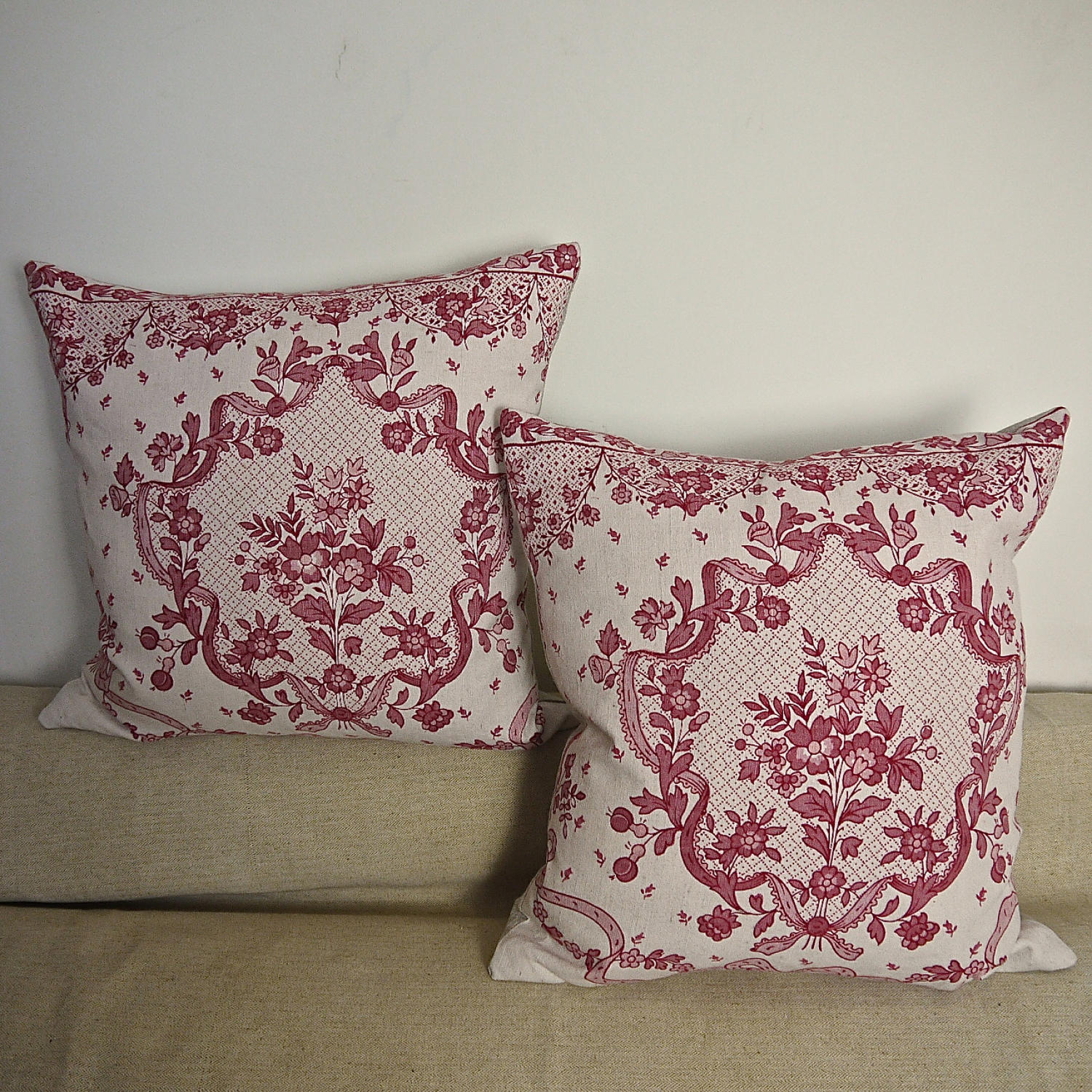 Pair of early 20thc French red and pink linen cushions