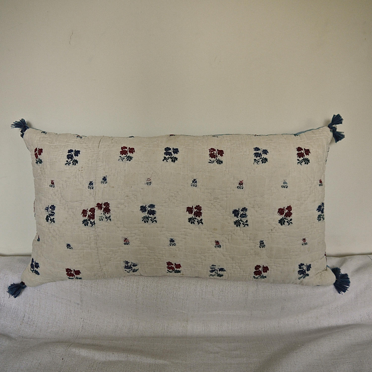 Wool woven flowers on linen cushion